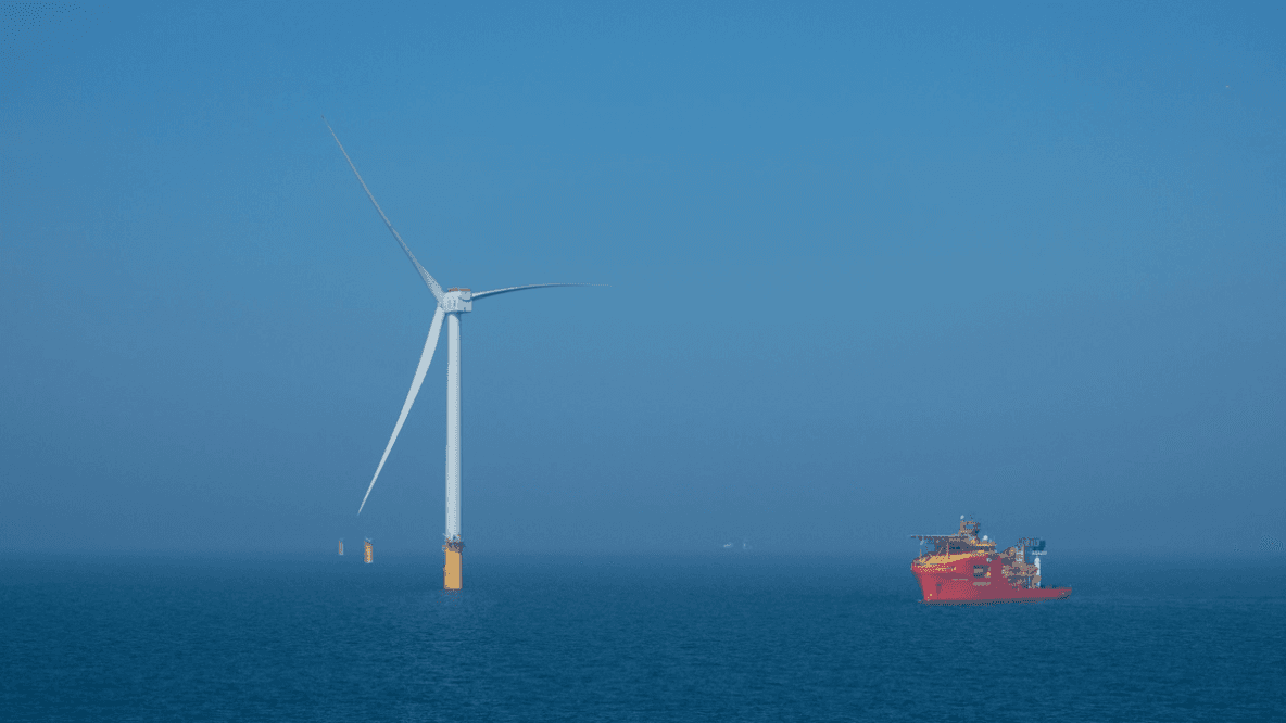 Wind turbine and support vessel at the Dogger Bank Wind Farm 