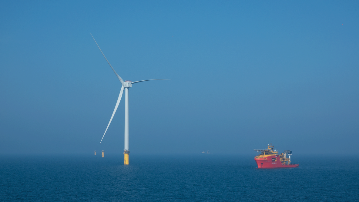 Wind turbine and support vessel at the Dogger Bank Wind Farm 