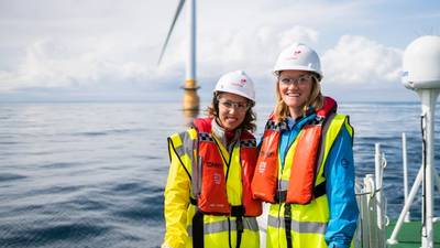 Two women offshore wearing protective equipment