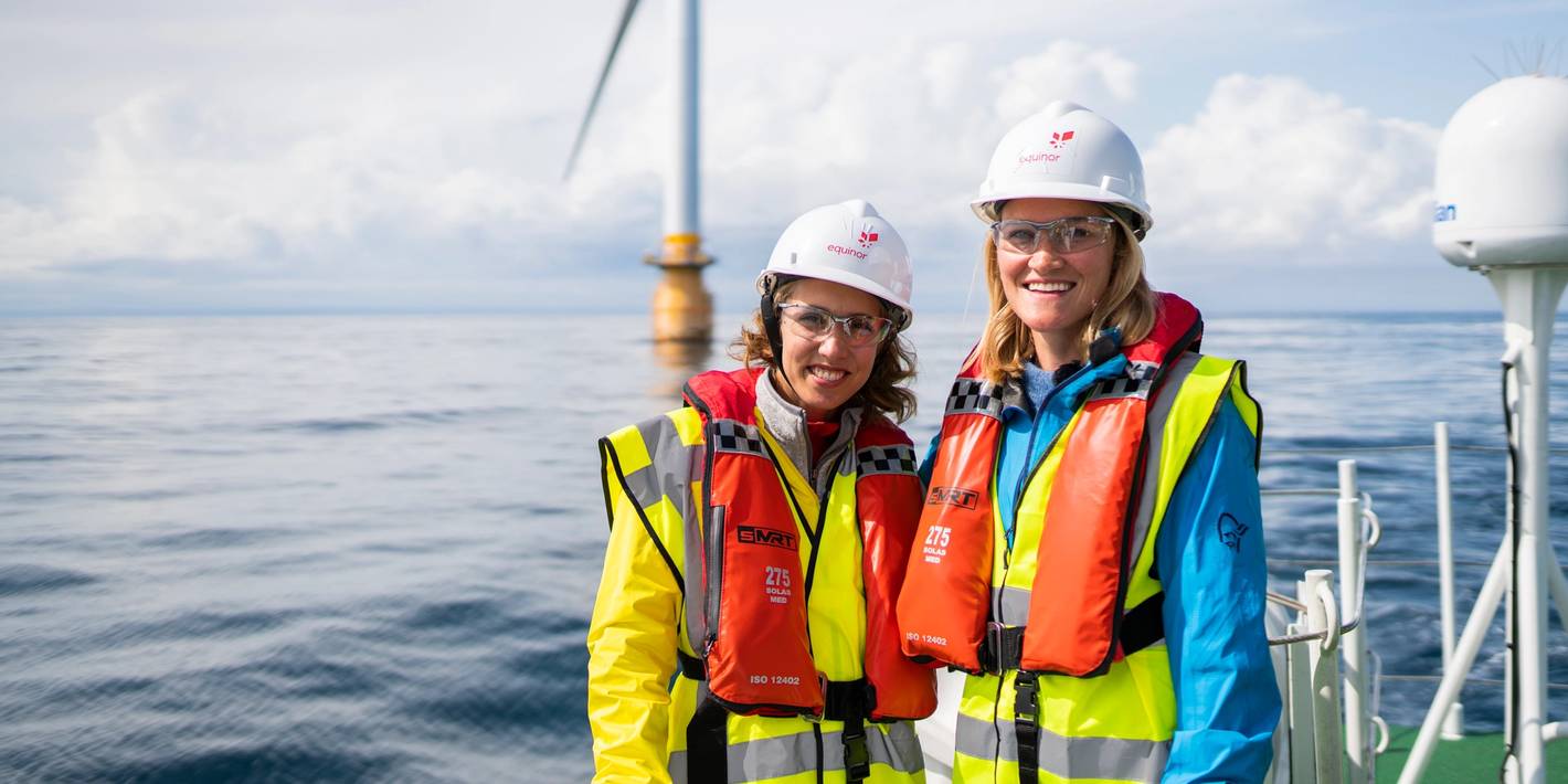 Two women offshore wearing protective equipment