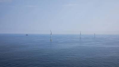 Photo of offshore oil platform and wind turbines at Hywind Tampen