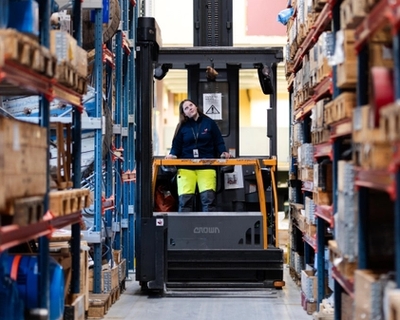 Young female apprentice on a truck in a storage. Photo