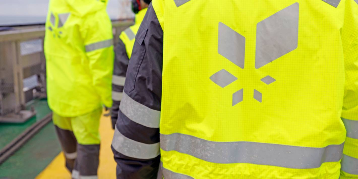 Offshore workers with Equinor logos on their backs