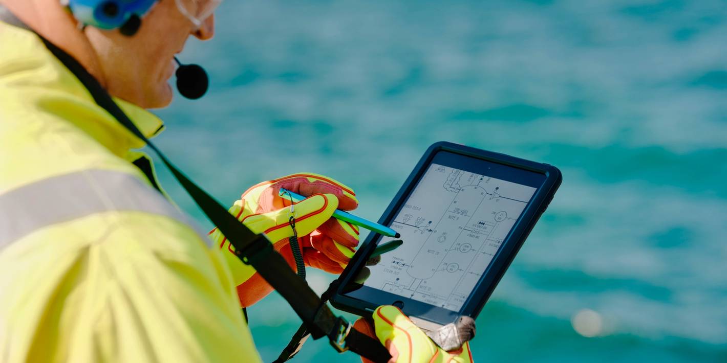 Equinor employee with digital tool in his hands